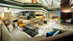 A spacious lobby with multiple seating areas, a bar, and a high ceiling with modern lighting fixtures. - Arts Hotel Istanbul - Special Class (Istanbul)
