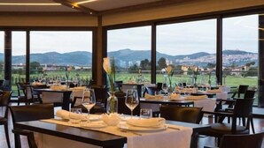 A restaurant with tables set for dining, large windows offering a view of the countryside. - Valle di Assisi Country Apartments (Assisi)
