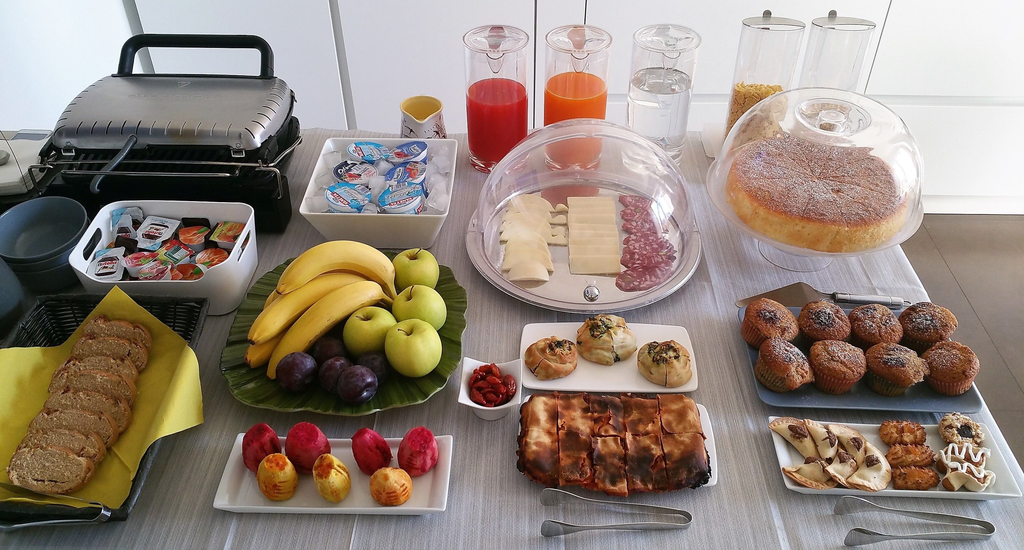 A breakfast buffet with various food items and beverages.