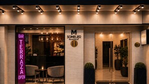 A modern hotel entrance with a bar named 'BAR TERAZA OPEN' and a sign for 'M SOMELIER HOTEL'. - Hotel Sommelier Agustinas (Santiago)