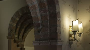 A stone archway and a wall-mounted light fixture.