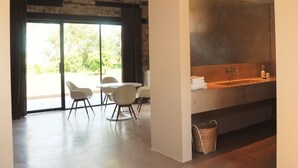 A modern bathroom with a large mirror, a sink, and a window. - Groot Noordhof (Nieuwpoort)