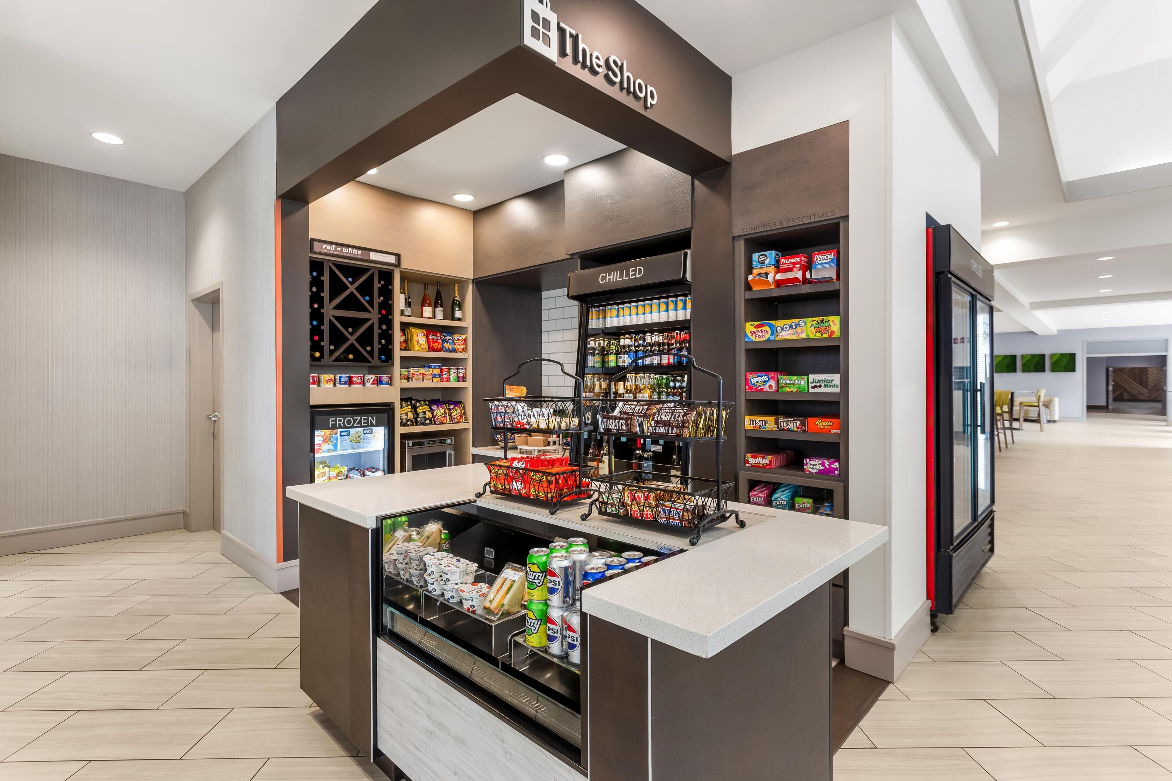 A self-service beverage kiosk with a variety of drinks and snacks, including a refrigerated section and a chilled section.