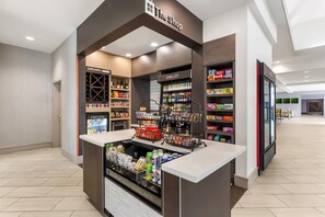 A self-service beverage kiosk with a variety of drinks and snacks, including a refrigerated section and a chilled section.