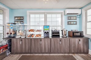 A bakery counter with various baked goods, a coffee machine, and a milk dispenser. - The Pelham Resort Motel (Hampton)