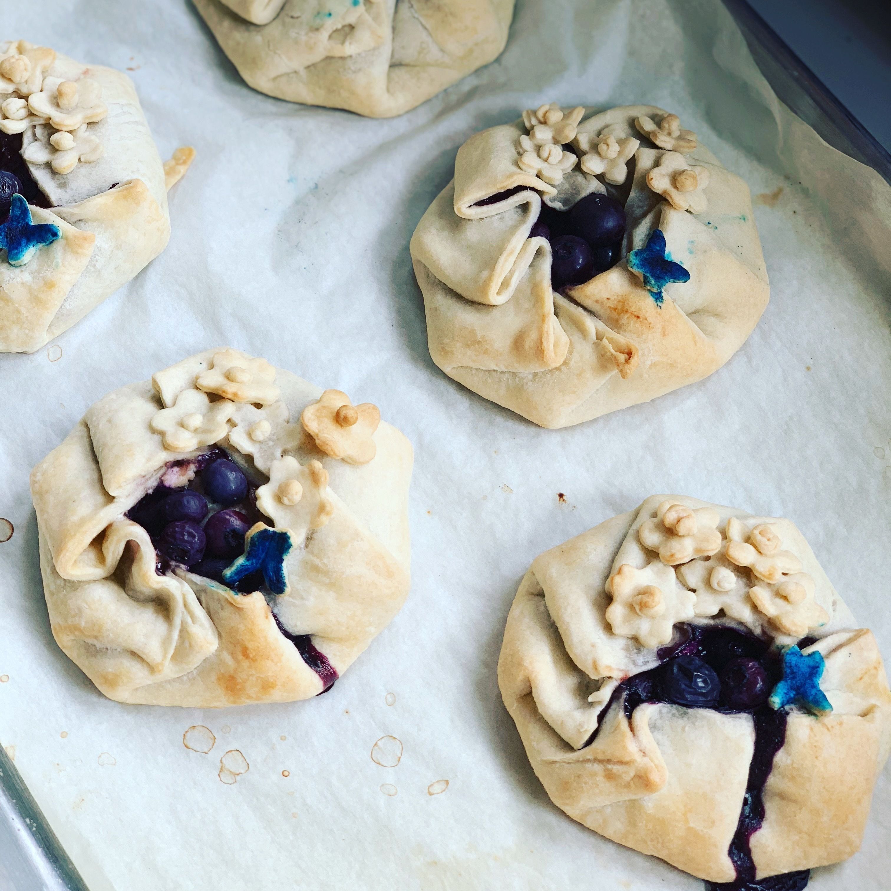 Four pastries on parchment paper.