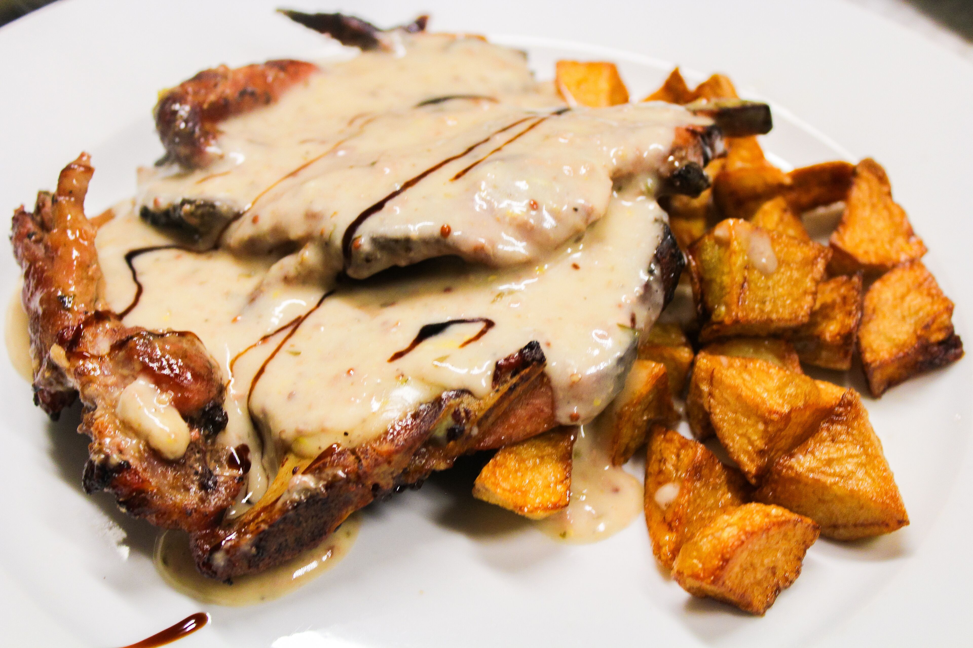 A plate with grilled meat and roasted potatoes.