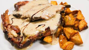A plate with grilled meat and roasted potatoes.