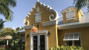 A yellow building with a sign reading "Buff & Wax" and a door labeled "Soleil Spa".