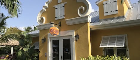 A yellow building with a sign reading "Buff & Wax" and a door labeled "Soleil Spa".
