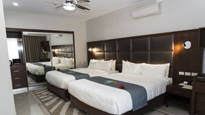A hotel room with a large bed, a mirror, a ceiling fan, and a nightstand. - The Palms Denarau Fiji (Nadi)