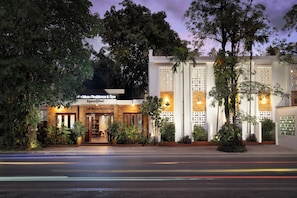 A hotel with a modern facade, large windows, and a well-lit entrance. - The Moon Residence & Spa (Siem Reap)