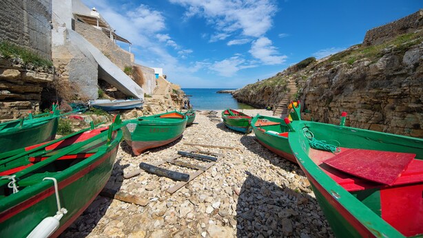 Boats docked on a rocky shore with a clear sky. - Cala Ponte, a Tribute Portfolio Hotel (Polignano a Mare)