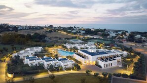 A resort with multiple white buildings, a swimming pool, and solar panels on the roofs. - Cala Ponte, a Tribute Portfolio Hotel (Polignano a Mare)