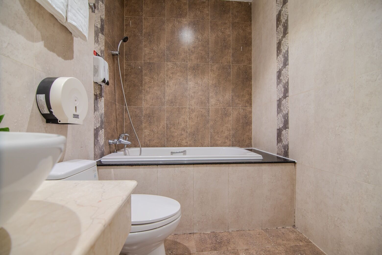 A bathroom with a toilet, a sink, and a shower.
