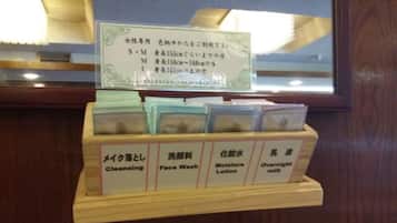 A wooden display with labeled compartments for skincare products including cleansing, face wash, moisture lotion, and overnight milk.