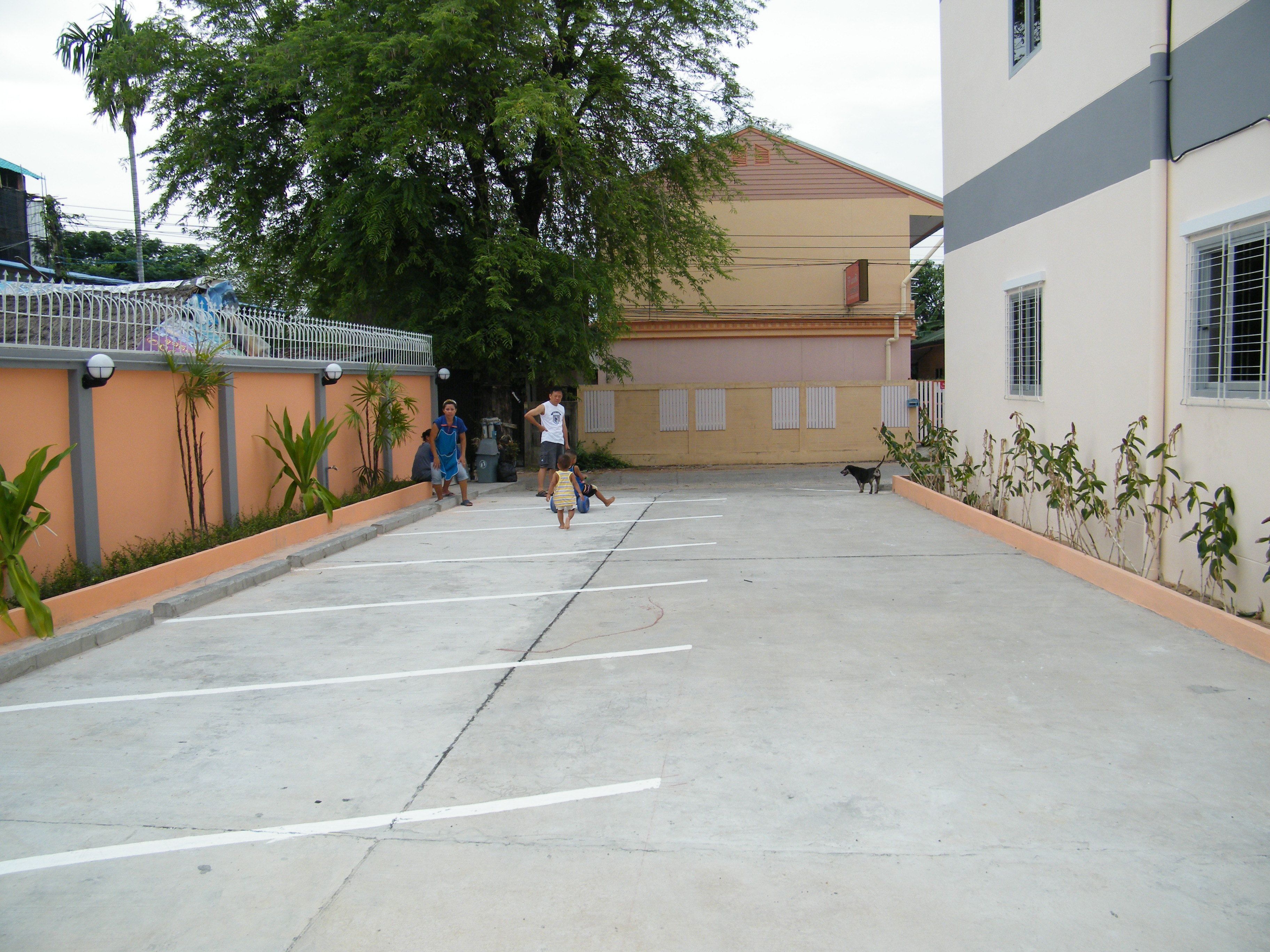 A parking area with a building in the background.