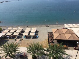 On the beach, sun loungers, beach umbrellas, beach towels
