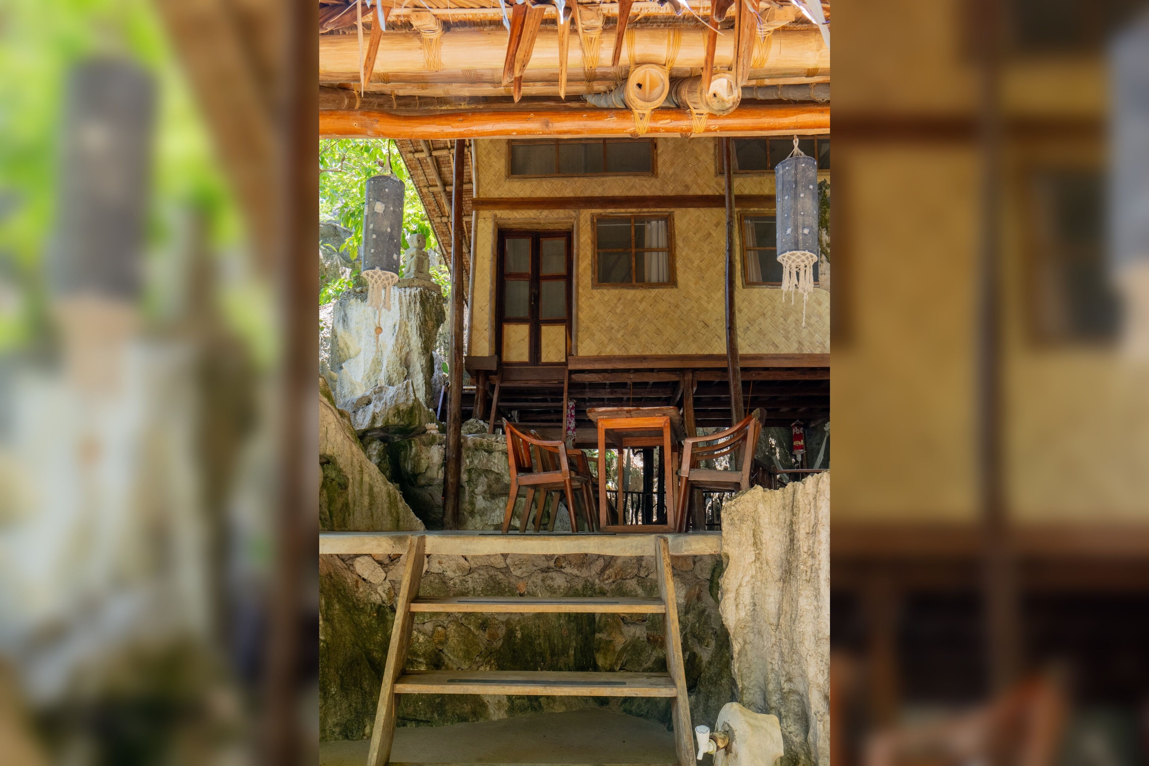 A traditional wooden building with a stone staircase leading to a wooden deck.