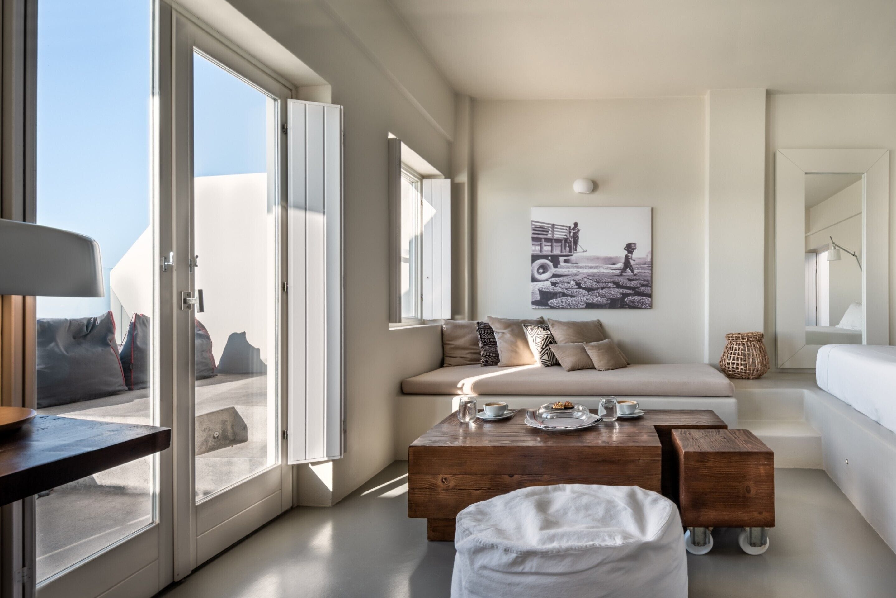A modern living room with a sofa, coffee table, and artwork on the wall.