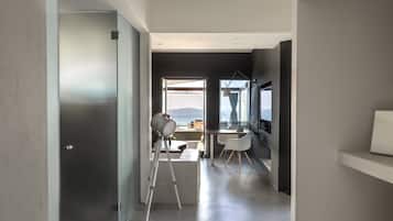 A modern interior with a desk, chair, and telescope.