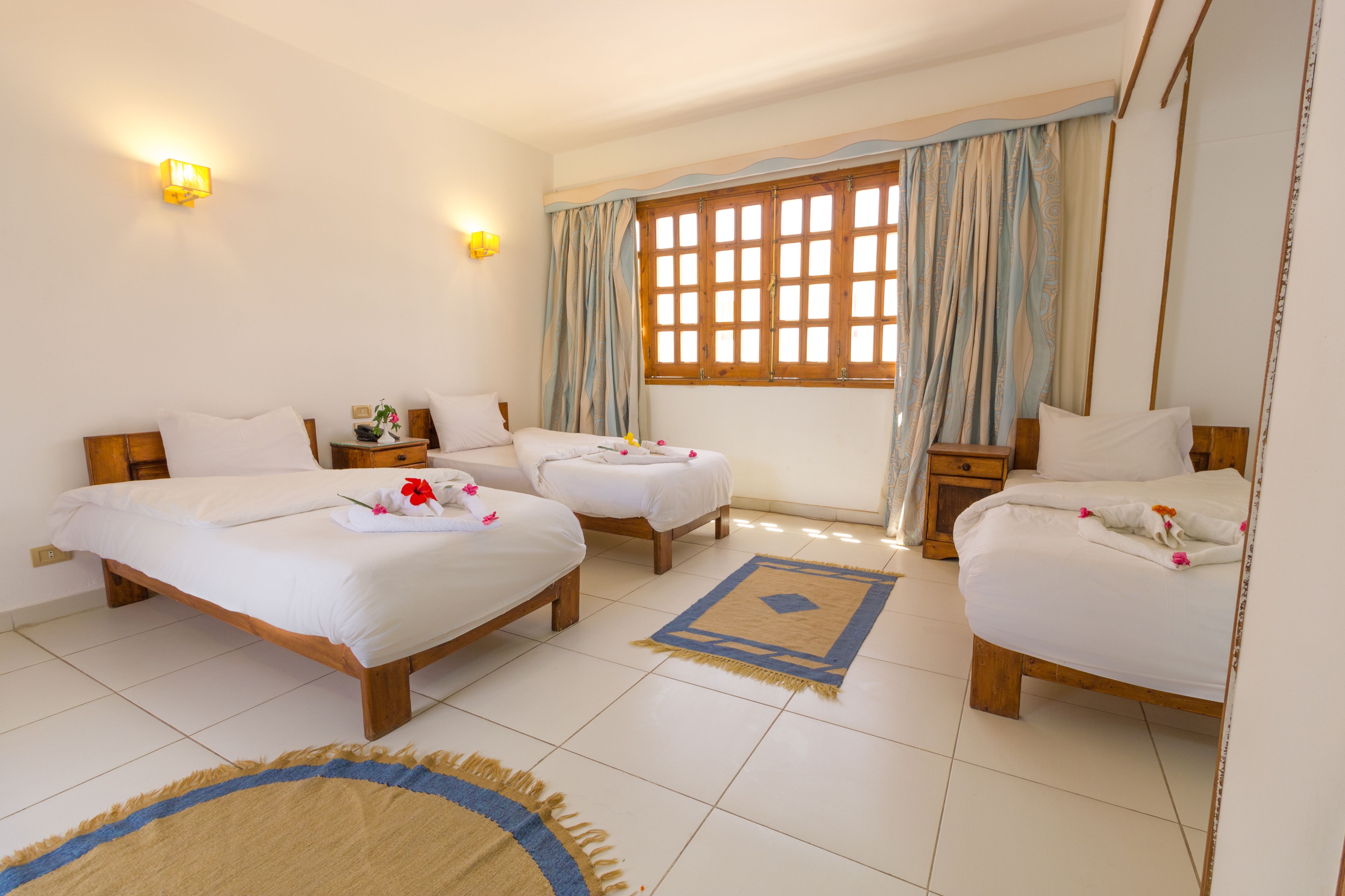 classic room (triple) | premium bedding, pillow-top beds, in-room safe, desk