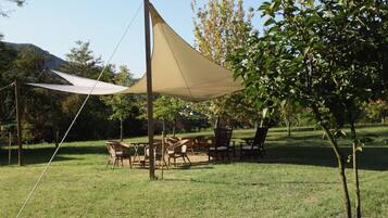 Relax in a serene outdoor space with comfortable seating and a shaded canopy.