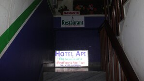 A staircase leading to a restaurant and hotel named 'Hotel Api'.