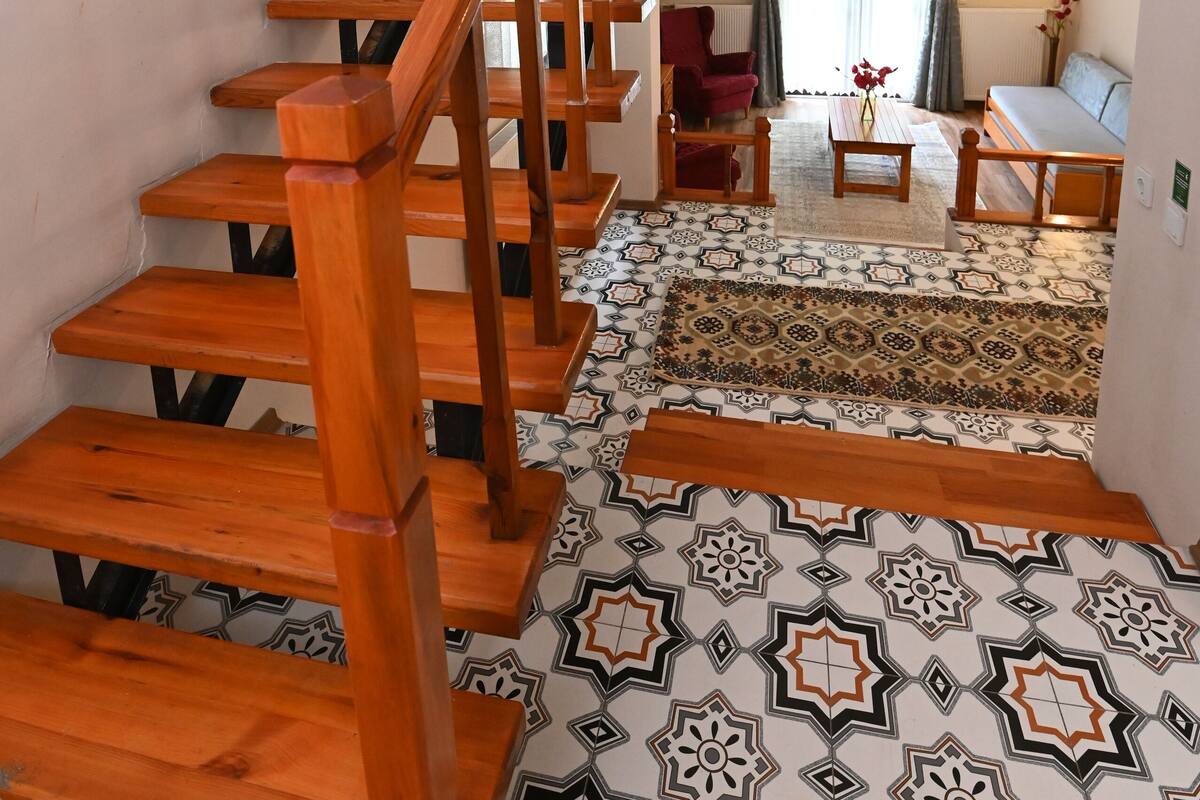 A staircase with wooden steps and a handrail leading to a second floor.