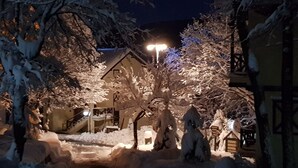 A snow-covered outdoor area with a building, a staircase, and a street lamp. - VONRESORT Abant (Bolu)