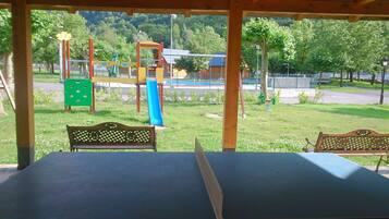 Una mesa de ping pong cubierta con bancos en un parque.