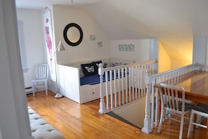 A child's bedroom with a bunk bed, a desk, and a chair. - Allston Red House (Boston)