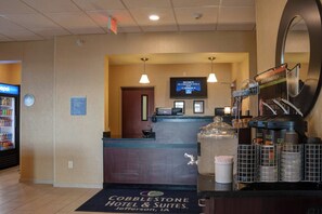 A hotel reception area with a digital screen, a coffee station, and a Pepsi refrigerator. - Cobblestone Hotel & Suites - Jefferson (Jefferson)