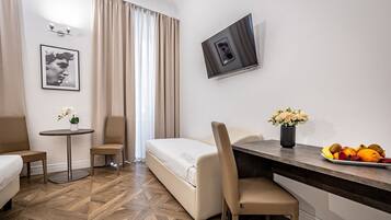 Quadruple Room | Minibar, in-room safe, individually decorated, desk