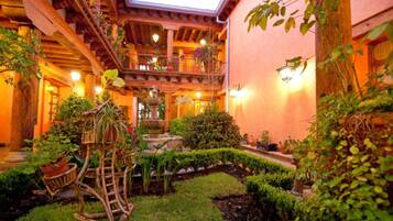 Stroll through this serene courtyard, surrounded by lush greenery and a tranquil fountain.