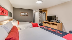 A hotel room with two beds, a desk with a TV, a coffee machine, and a coat rack.