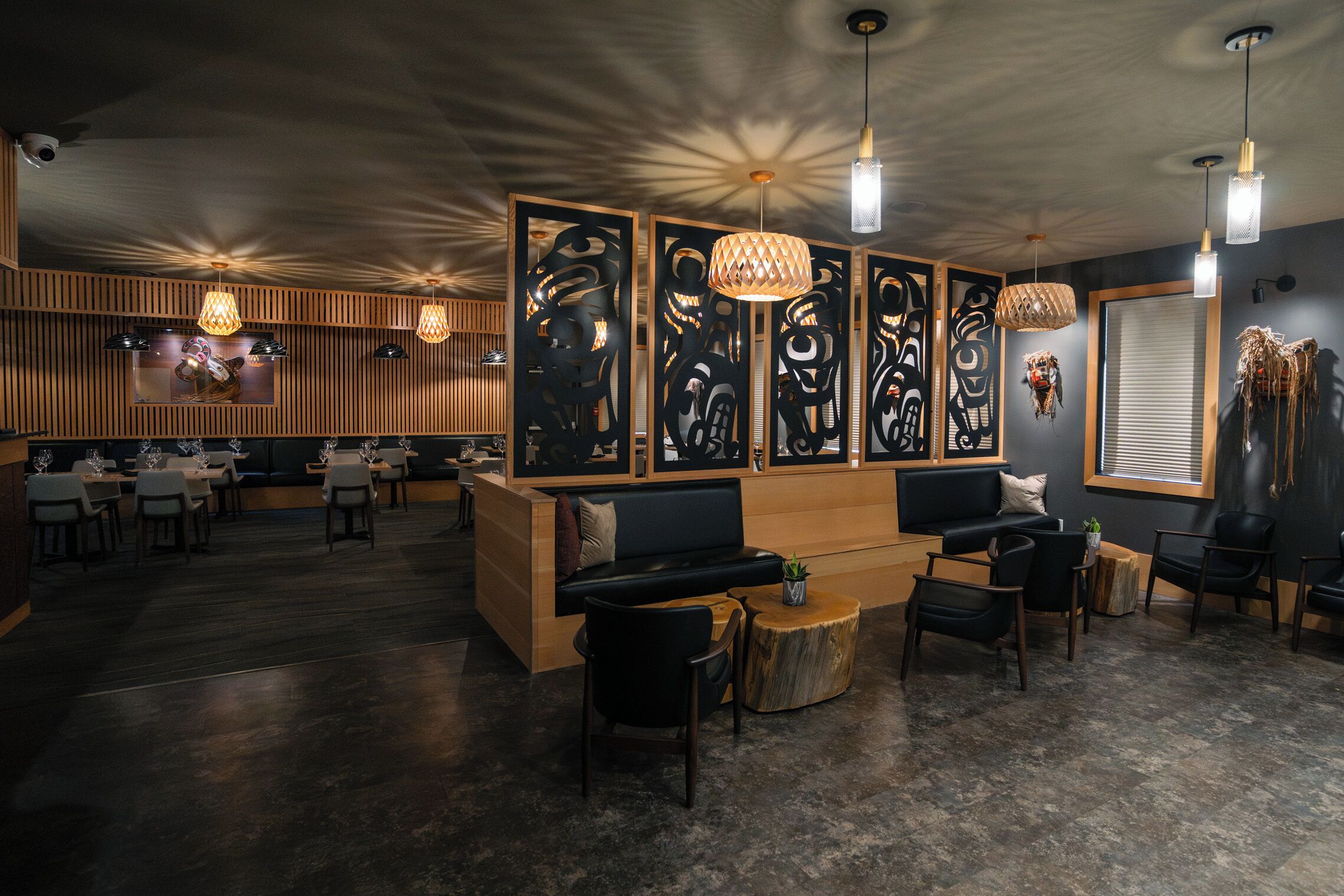 A modern interior with a reception desk, seating area, and dining space.