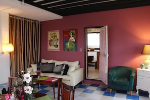 A living room with a checkered floor, a sofa, a green armchair, and a lamp. - Shirahama Club (Minamiboso)