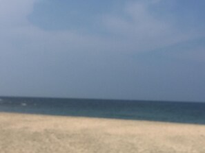 A beach with a clear sky and calm sea.