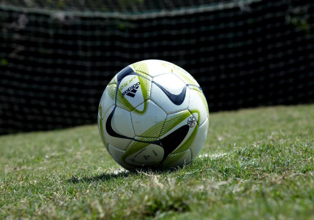 A soccer ball on a grassy field.