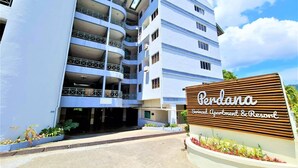A multi-story building with a sign reading "Pendana Serviced Apartment & Resort". - Perdana Serviced Apartment & Resorts (Langkawi)