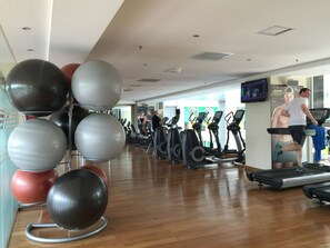 A gym with exercise equipment, including treadmills and exercise balls.