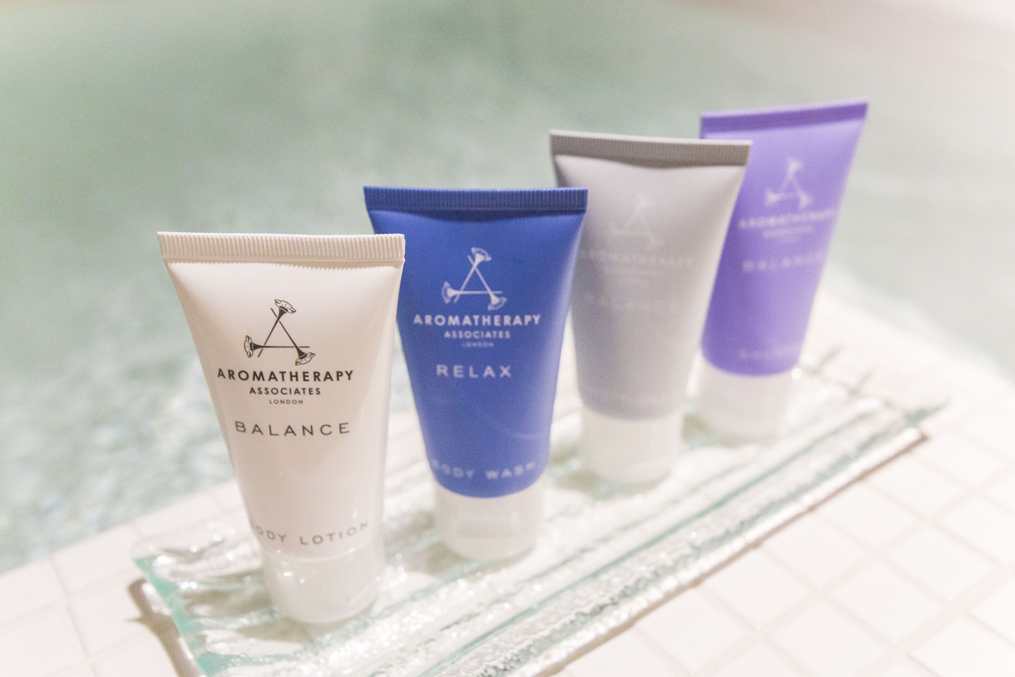 Four tubes of body lotion with different labels.