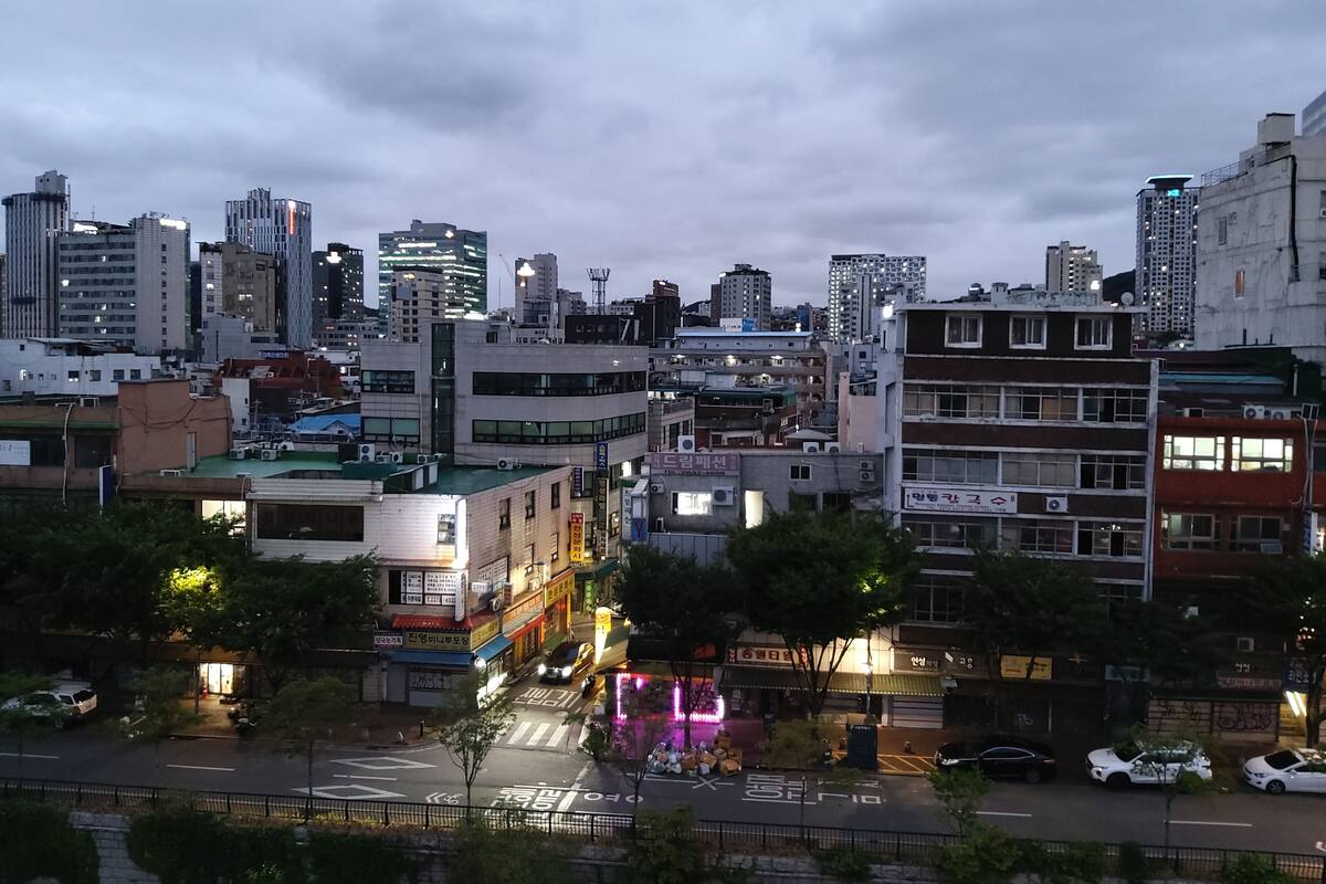 A cityscape with various buildings, including a mix of residential and commercial structures.