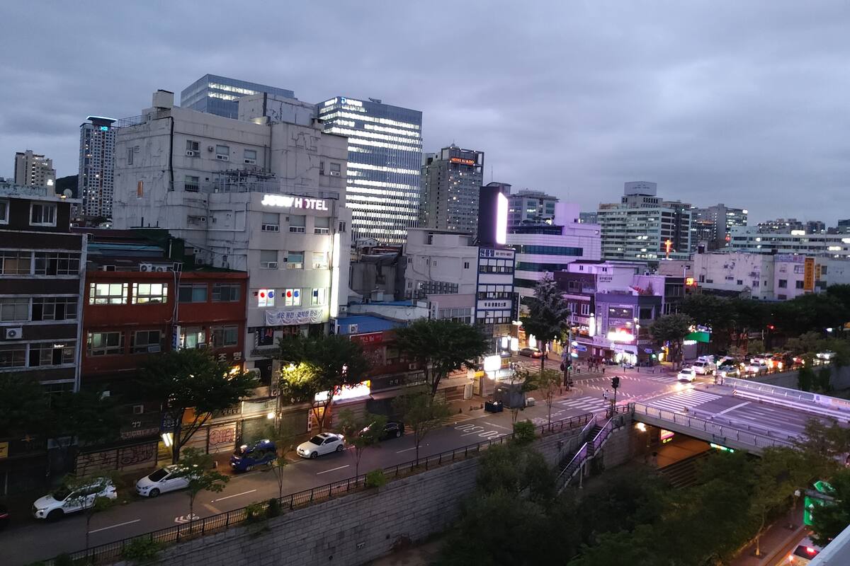 A cityscape with a hotel named "HOTEL H" prominently displayed.