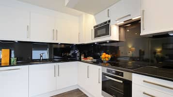 Three Bedroom Deluxe | Private kitchen | Full-size fridge, microwave, oven, stovetop