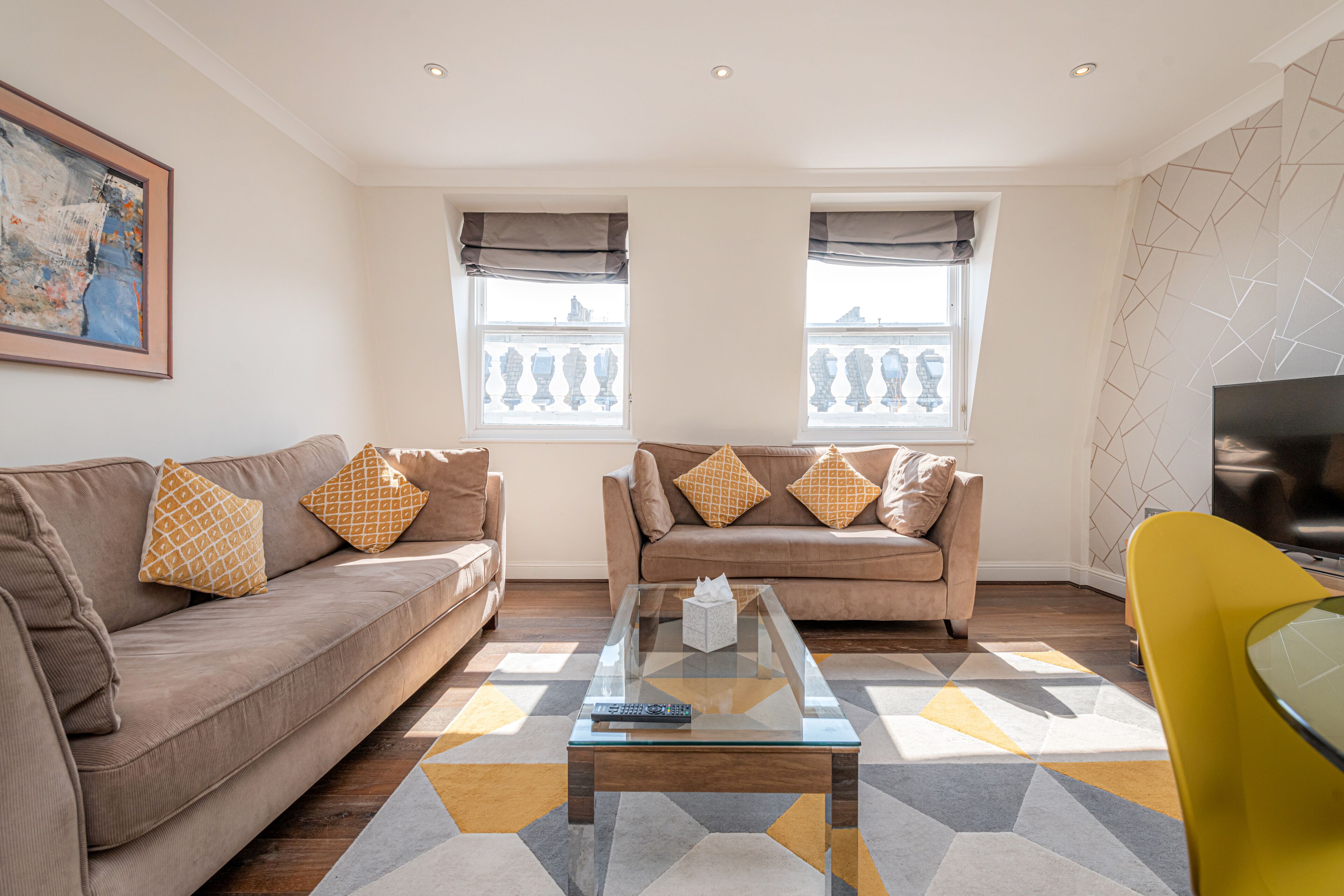 A living room with two sofas, a coffee table, and a TV.