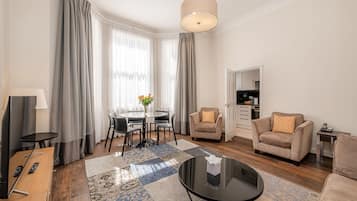 Deluxe Apartment, 2 Bedrooms | Living area | Flat-screen TV, DVD player