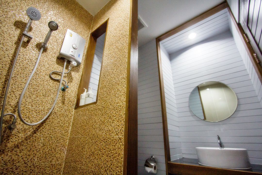 A bathroom with a shower, a sink, and a mirror.