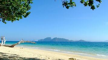 On the beach, sun-loungers, beach umbrellas, beach towels